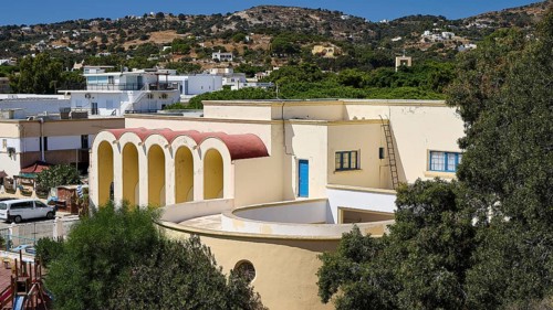 Primary school, Panorama of a Mediterranean building with arches and hills in the background,