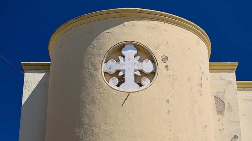 Primary school, Round tower with white cross on a beige wall under a clear sky, Historicism, Art