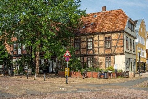Half-timbered building with red bricks on a quiet street. Bicycles are also available, Verden an