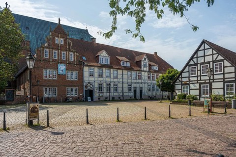 Historic half-timbered houses on a sunny day. Quiet neighbourhood, paved square, Verden an der
