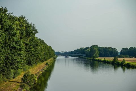 Canal with bridge and green banks, peaceful and quiet surroundings, Weser cycle path, district of