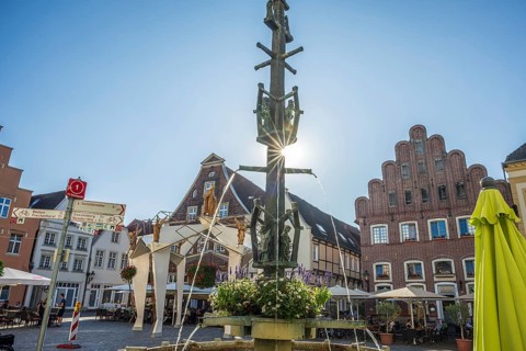 A fountain with fountains in a central square surrounded by half-timbered houses, Warendorf,