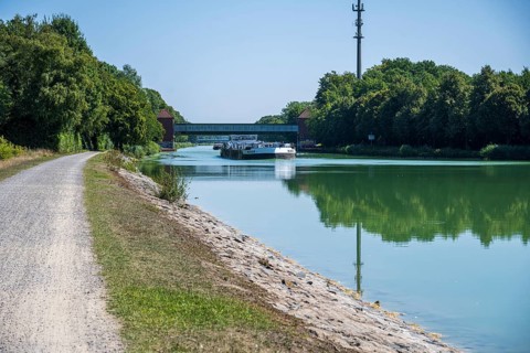 Canal with riverside path and bridge. Natural scenery with a summer atmosphere, Dortmund-Ems Canal