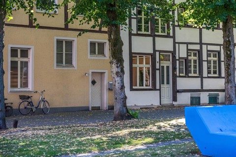 Quiet street scene with half-timbered houses, a bicycle and a summery atmosphere, Marienkirchplatz,
