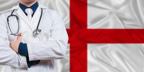 Male doctor with stethoscope on England flag. Doctor holding stethoscope on England flag