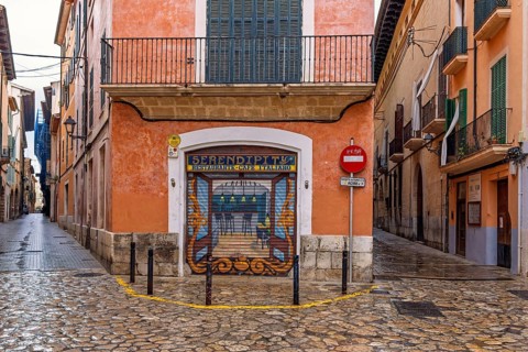 Mural painting on a jalousie to a street corner restaurant in the old town of Palma, Palma de