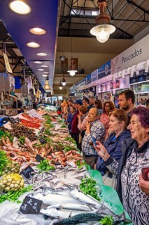 People shopping at a fish stall in fish market at a market hall, Palma de Mallorca, Mallorca, Spain