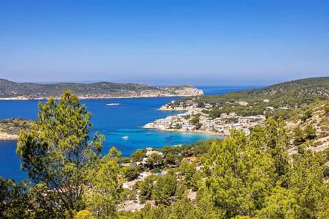 Seascape view at a coastal village on the Mediterranean Sea with a rocky coastline and lush green