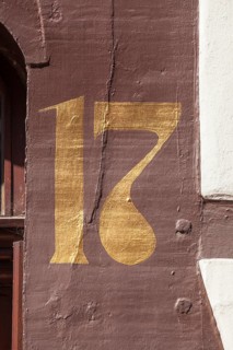 Golden house number plate number seventeen on a half-timbered house in the old town centre,