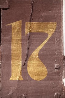 Golden house number plate number seventeen on a half-timbered house in the old town centre,