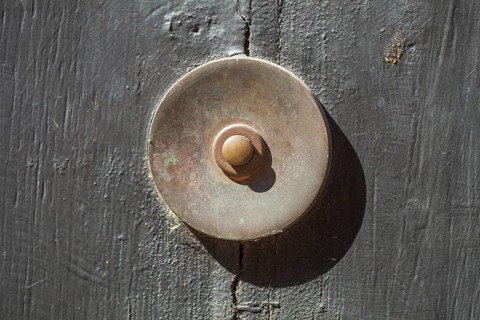 Old bell on a half-timbered house in the old town centre, Hamelin, Lower Saxony, Germany
