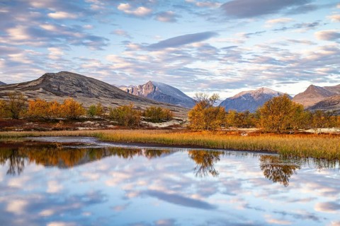 Reflection of the autumn landscape in Rondane National Park, Berge, Døråldalen, Norway