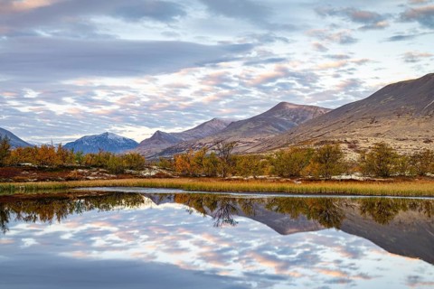 Reflection of the autumn landscape in Rondane National Park, Berge, Døråldalen, Norway