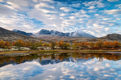 Autumn landscape in Rondane National Park, mountains Høgronden, Midtronden and Digerronden Dørålen,