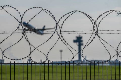 Symbolic image security at the airport, outer fence at Düsseldorf International Airport, steel wire