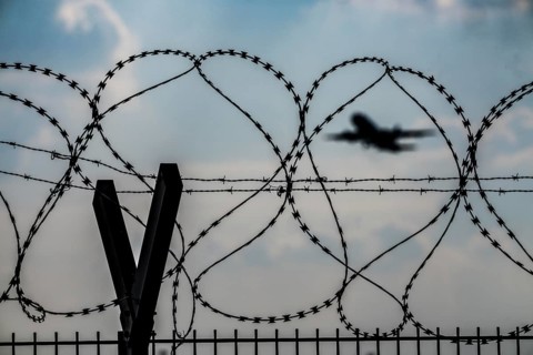 Symbolic image security at the airport, outer fence at Düsseldorf International Airport, steel wire