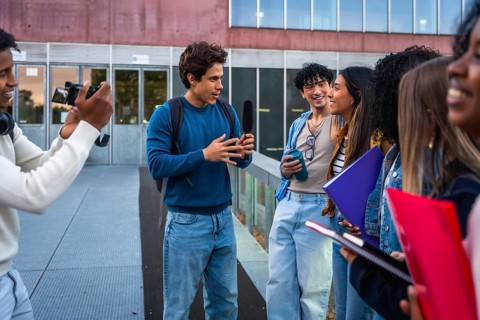 Students on university campus creating social media content, interviewing for a vlog or podcast,