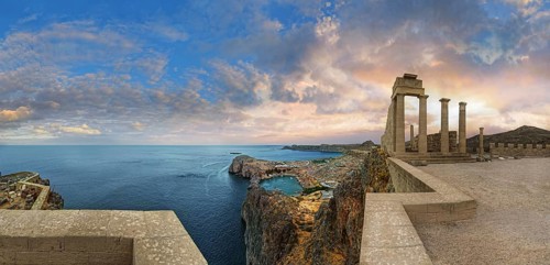 Breathtaking view from the Acropolis of Lindos with columns of the Temple of Athena at sunset and