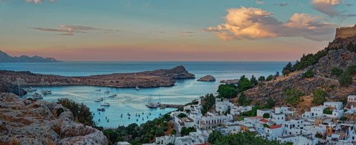 Harbour and coast of Lindos with boats at sunset, Acropolis, Lindos, Rhodes, Island, Greece