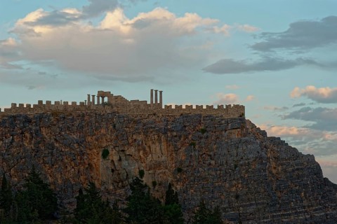 The ancient Acropolis of Lindos on jagged rocks against a dramatic sky at dusk, Acropolis, Lindos,
