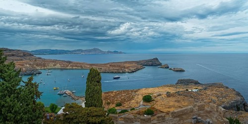 View of the coastal landscape of Lindos with the harbour full of boats, Acropolis, Lindos, Rhodes,
