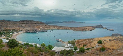 Harbour and coast of Lindos with boats and cloudy sky, Acropolis, Lindos, Rhodes, island, Greece