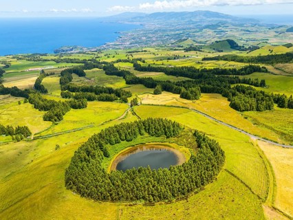 Lake Pau Pique and Lush Green Hills with Pasturelands on Sunny Day. Atlantic Ocean. Azores, Sao