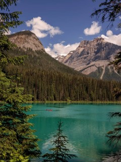 Kayak on Emerald Lake encircled by the Canadian Rocky Mountains and forest within Yoho National