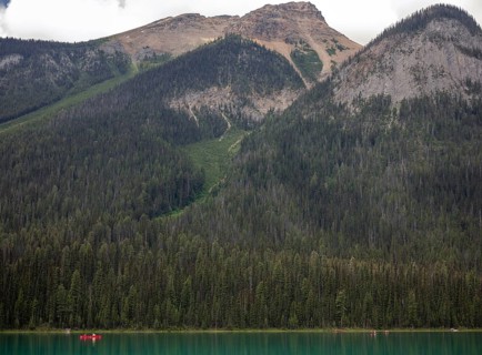 Vast forest of the Canadian Rocky Mountains and a serene Emerald Lake inside Yoho National Park,