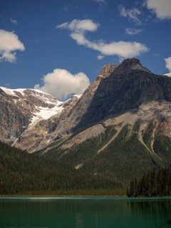 Towers of snowy peaks of the Canadian Rocky Mountains next to Emerald Lake inside Yoho National