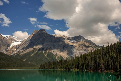 Majestic mountain range of the Canadian Rocky Mountains and Emerald Lake under a clear sky inside