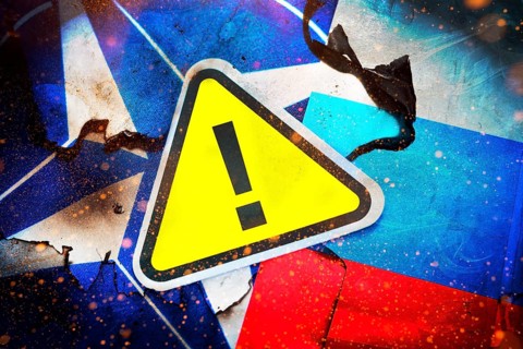 The flags of NATO and Russia with danger sign, photomontage