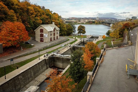 Elevated view of the Rideau canal and locks leading to the Ottawa River, lined by an autumn path