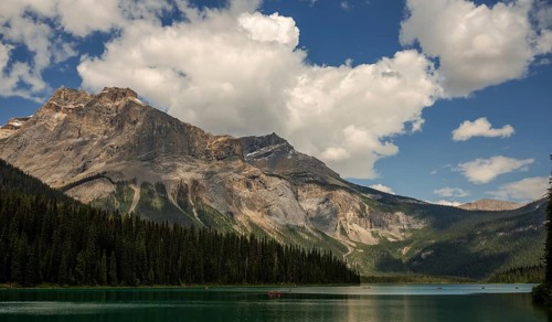 Serene mountain view of the Canadian Rocky Mountains with clear Emerald Lake reflecting a dramatic