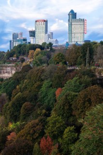 City skyscrapers rise above lush, colorful trees and natural landscape in Niagara Falls, Ontario,