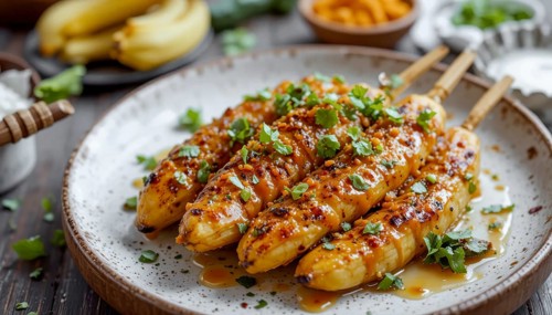 A close-up shot showcases delicious grilled banana skewers, drizzled with a glossy glaze and