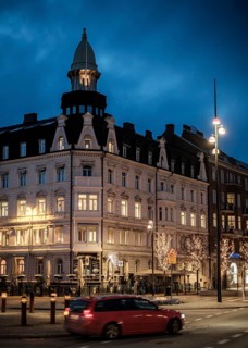 Historic building illuminated at night in a city area with streetlights in Helsingborg, Sweden,