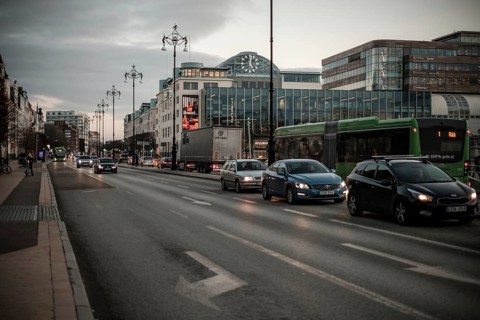 Busy evening traffic on a city road, surrounded by modern buildings in Helsingborg, Sweden,