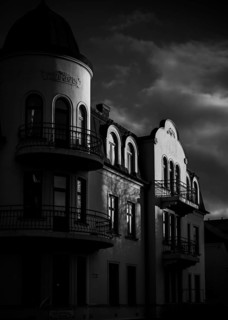Historic European building in black and white with dramatic shadows and cloudy sky in Helsingborg,