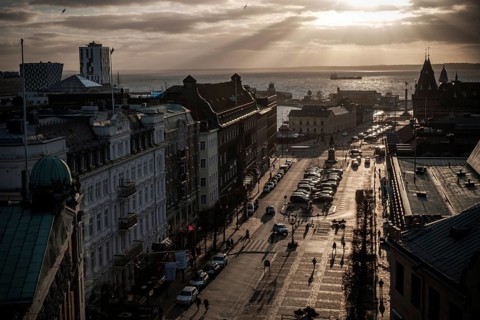 A street leading to the Oresund Strait under a dramatic sunset and clouds as seen from Helsingborg,