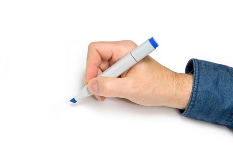 Male hand with felt tip pen in light back