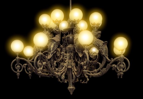 Illuminated historic dusty chandelier in black back