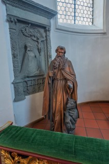 Church of St Gallus and Ulrich, figure of St Gallus with the bear next to an epitaph, Kisslegg,