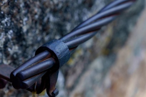 Steel cable railing showing a strong metal connection detail on a stone wall in ronda, malaga,