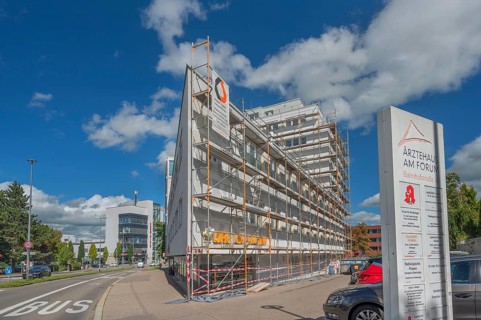 Blue sky, white clouds, scaffolded medical centre at the Forum, Kempten, Allgäu, Swabia, Germany
