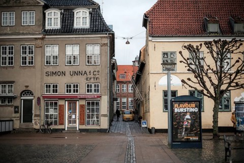 Narrow alley between historic buildings with a poster on the wall in Helsingor, Denmark, Northern