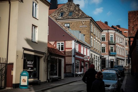 Charming street with colorful buildings and a hotel under a blue sky in Helsingborg, Sweden,