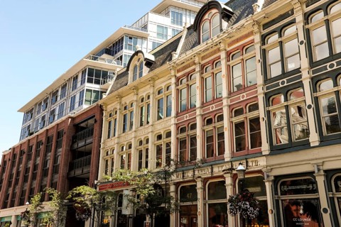 Row of historic buildings with ornate facades under a clear blue sky in Toronto, Ontario, Canada,