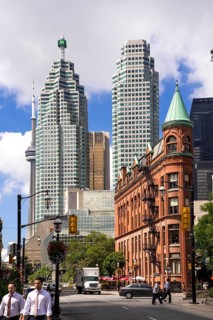 A mix of historic and modern buildings under a bright sky in Toronto, Ontario, Canada, North