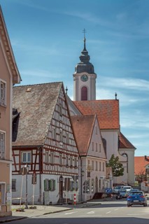 Pointed gable house with half-timbering and St Gallus and Ulrich church, Kisslegg, Allgäu,